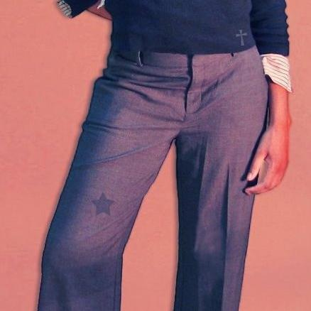 Ambriel — navy sweater with a small cross, striped cuffs, grey slacks with a star